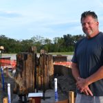 Artist Robert Wertz at the installation of his Rock of Our Salvation Fountain at Queen of Angels Cemetery, Sept. 9, 2024. The igneous rock that forms the fountain is 45 million years old and is part of the Gospel Gardens in Phase 2. (GLENDA MEEKINS)
